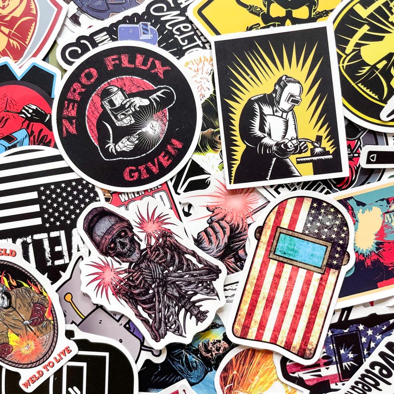 May include: A collection of stickers featuring welding themes. Designs include a welder with the text "Zero Flux Given", a skeleton welding, and an American flag-themed welding mask. The stickers are in various shapes and sizes.