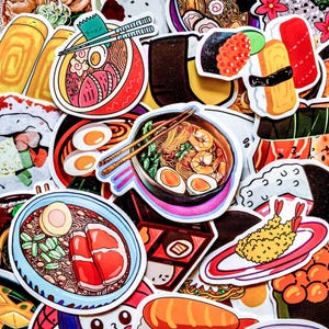May include: A collection of colorful stickers featuring various Japanese food illustrations. The stickers depict ramen bowls, sushi, tempura, and other dishes. The designs include vibrant colors and detailed artwork, perfect for decorating notebooks or personal items.