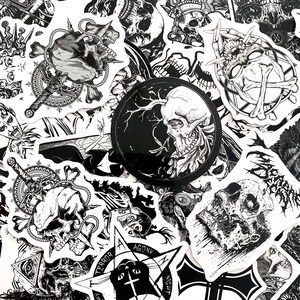May include: A collection of black and white stickers featuring skull illustrations, daggers, and gothic symbols. The stickers vary in shape and size, with intricate details and a dark aesthetic. Some stickers include text like "Terror" and "Agony".
