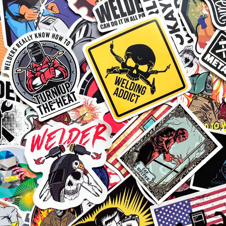 May include: A collection of colorful stickers with welding-themed designs. The stickers feature images of welders, skulls, and text like "Welding Addict" and "Turn Up The Heat". The stickers are in various shapes and sizes, with a mix of bold colors and graphic illustrations.