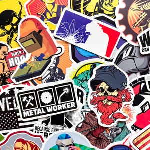 May include: A collection of colorful stickers featuring welding-themed designs. The stickers include images of welders, welding tools, and the text "METAL WORKER". The color palette includes orange, blue, red, and black.