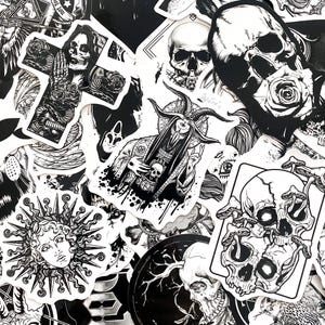May include: A collection of black and white stickers featuring gothic and occult imagery. Designs include skulls, crosses, sun faces, and figures with horns. The stickers vary in size and shape, creating a layered effect.