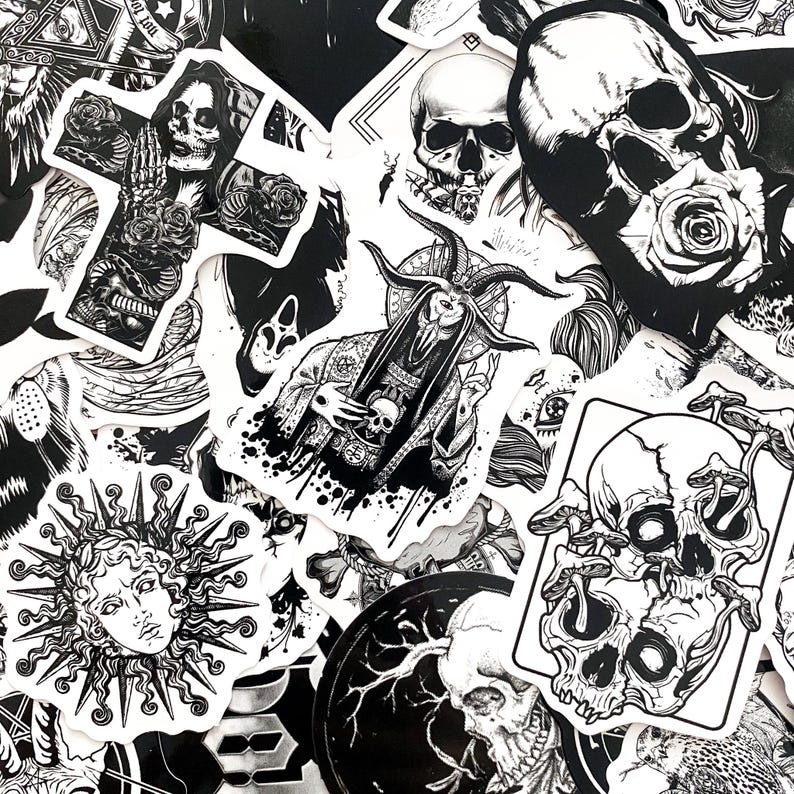 May include: A collection of black and white stickers featuring gothic and occult imagery. Designs include skulls, crosses, sun faces, and figures with horns. The stickers vary in size and shape, creating a layered effect.