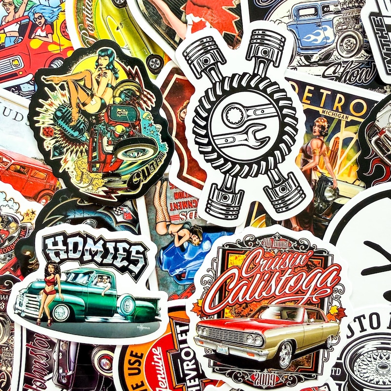 May include: A collection of colorful stickers with vintage car and pin-up girl designs. The stickers feature text like "Cruisin' Calistoga", "Homies", and "Retro Michigan". The color palette includes red, green, gold, and blue.