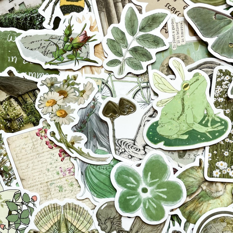 May include: A collection of decorative stickers featuring botanical and nature-themed illustrations. The stickers include images of flowers, leaves, insects, a frog, and vintage-style text. The color palette is primarily green, white, and sepia tones.