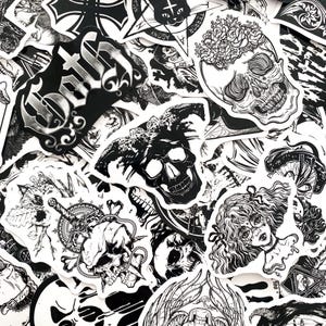 May include: A collection of black and white stickers featuring gothic and macabre designs. The stickers include skulls, floral elements, and text, creating a dark and artistic aesthetic. The stickers are of various shapes and sizes.