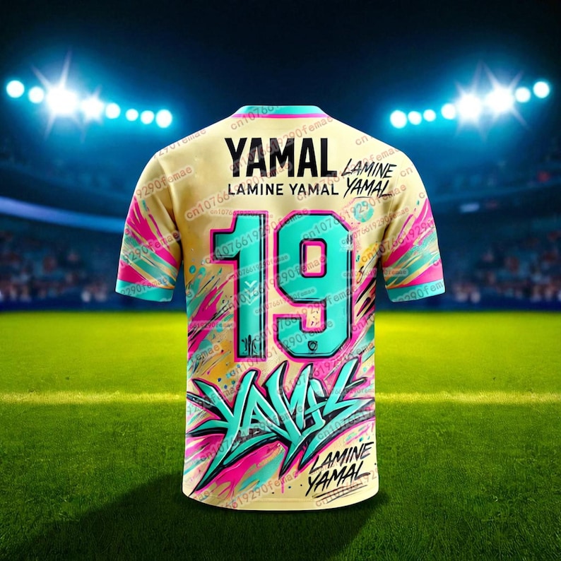 May include: A yellow soccer jersey with the name "YAMAL" and the number "19" in teal. The jersey has a colorful design with pink and teal accents. The name "LAMINE YAMAL" is also printed on the jersey.