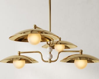 Luxury Brass Chandelier with Sculptural Curved Arms and Elegant Glass Globe Accents