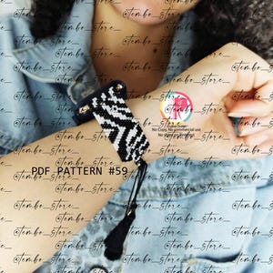 May include: A black and white beaded bracelet with a geometric zigzag pattern. The bracelet has a dark blue leather backing and a black tassel. The text "PDF PATTERN #59" is visible.