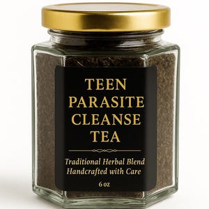May include: A hexagonal glass jar with a gold lid, filled with a dark brown herbal blend. The jar has a black label with gold text that reads "TEEN PARASITE CLEANSE TEA." The label also states "Traditional Herbal Blend Handcrafted with Care" and "6 oz."
