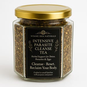May include: A hexagonal glass jar with a gold lid filled with loose tea. The jar has a black label with white text that reads "Intensive Parasite Cleanse Tea." The label also includes the text "Herbal Support for Detox. Parasites & Eggs."