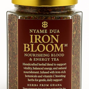 May include: A glass jar with a gold lid, filled with dried herbs. The label reads "NYAME DUA IRON BLOOM" and describes it as a nourishing blood and energy tea. The label is a deep red color with gold lettering.