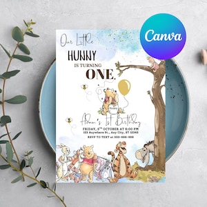 May include: A birthday invitation featuring Winnie the Pooh characters. The invitation has the text "Our Little Hunny is Turning One" and includes the party details. The design includes illustrations of Pooh, Piglet, Tigger, Eeyore, and other characters.