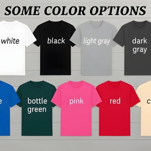 a collection of t-shirts in various colors, including white, black, light gray, dark gray, blue, green, pink, red, and cream.