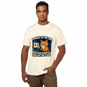 A man wearing a white t-shirt with a graphic design featuring a cat and text that says "99 Bugs in the Code" and "Take one down 127 Bugs in the Code".