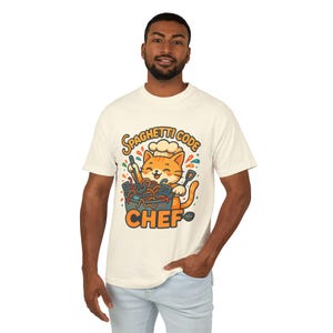 A man wearing a white t-shirt with a graphic design of a cat wearing a chef's hat and holding a bowl of spaghetti.