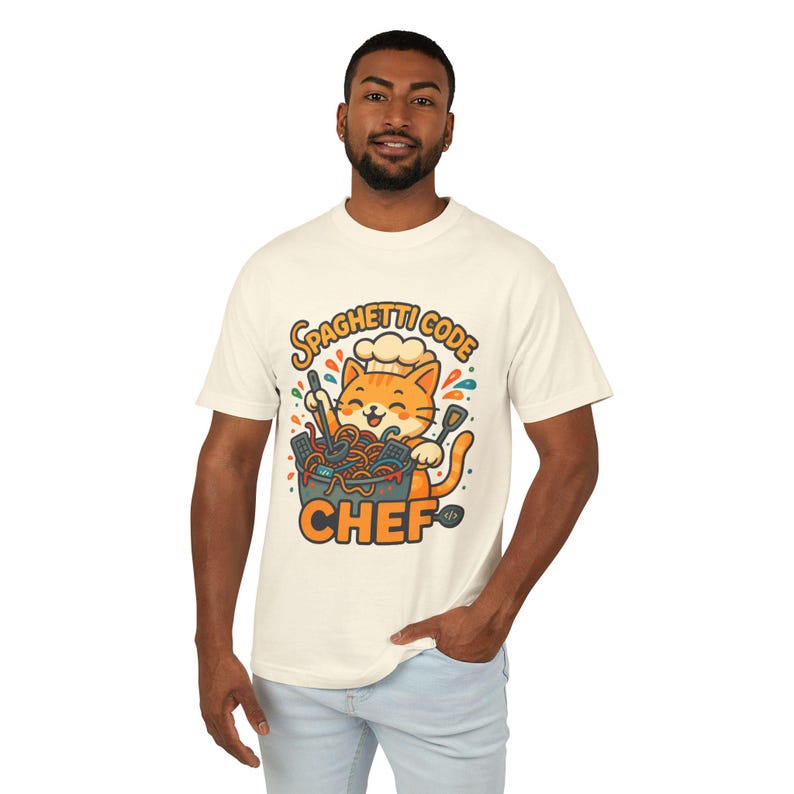 A man wearing a white t-shirt with a graphic design of a cat wearing a chef's hat and holding a bowl of spaghetti.