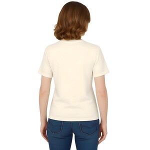 A woman with long brown hair is shown from the back, wearing a white t-shirt and blue jeans.