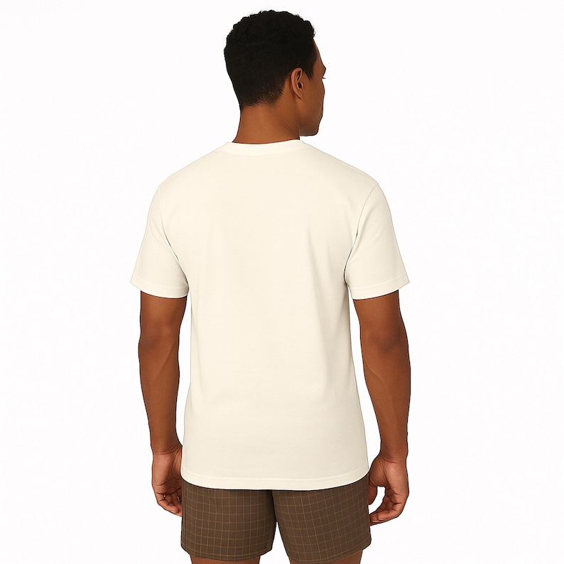 A man wearing a white t-shirt and brown shorts is facing away from the camera.