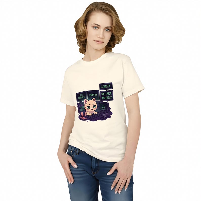 A woman wearing a white t-shirt with a graphic design of a cat and text that says "COMMIT, ERASE, PREPARE".