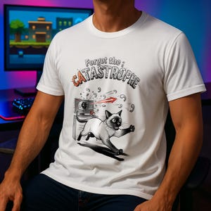Könnte beinhalten: Weißes T-Shirt mit einer Cartoon-Illustration einer Siamkatze, die vor einem Computerbildschirm flieht. Der Text "Forgot the; CATASTROPHE" ist über der Katze und dem Bildschirm aufgedruckt.