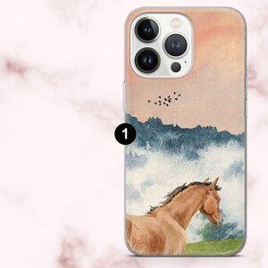 May include: A clear phone case with a watercolour painting of a brown horse in a landscape with mountains, birds, and a sunset. The case has a clear border and a camera cutout.