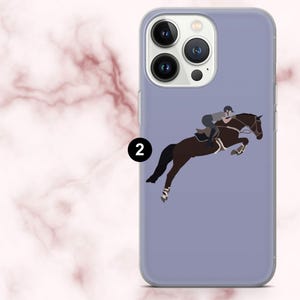 May include: A lilac phone case with a graphic of a horse and rider in mid-jump. The illustration shows a brown horse with a rider in riding gear. The case has a transparent edge and a black number 2.