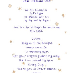 May include: White card with blue text and gold star illustrations. The text reads "Dear Precious One" followed by a prayer. The prayer includes phrases like "God's Light", "Jesus", and "Angels".