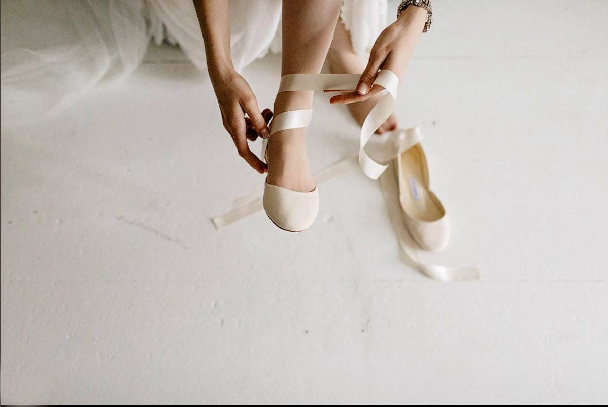 white satin ballet shoes with ribbon