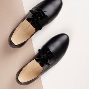 top view of a pair of smooth black leather oxford shoes