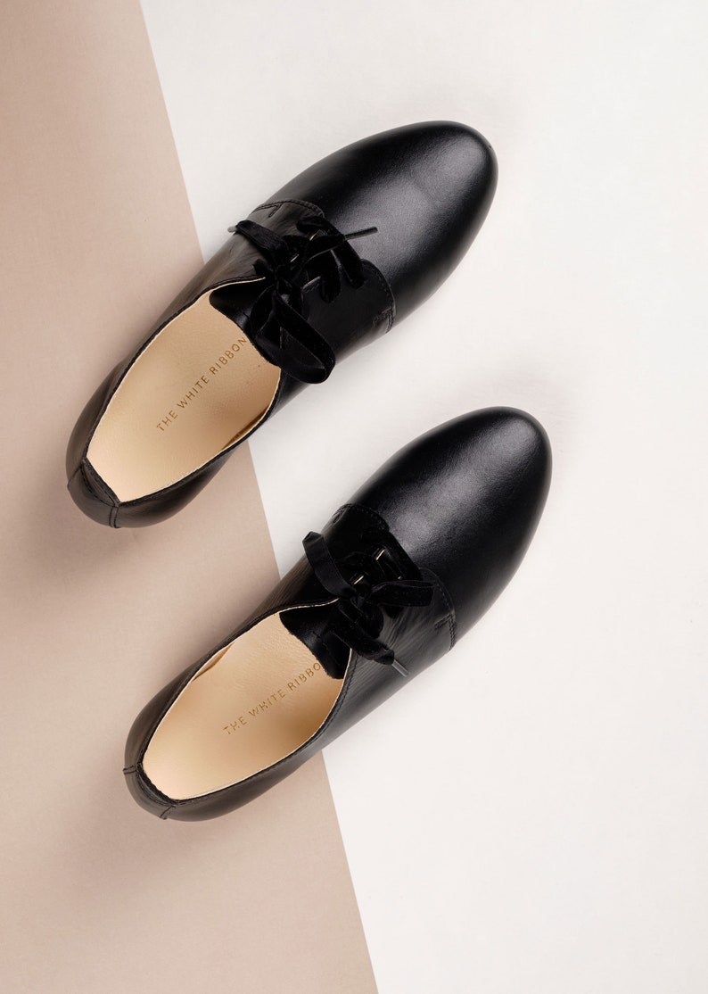 top view of a pair of smooth black leather oxford shoes