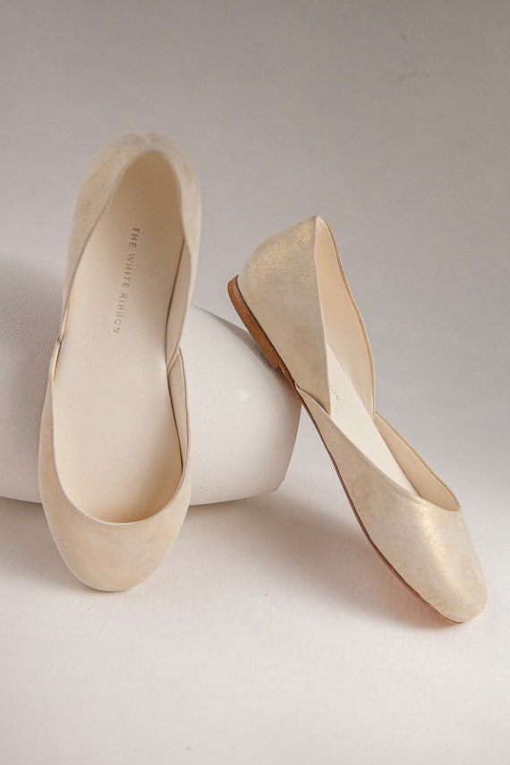 white and gold flats