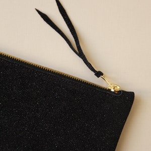 close up shot of a sparkling black leather clutch