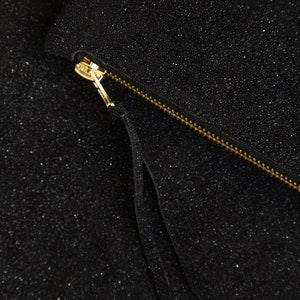 close up shot of sparkling black leather purses