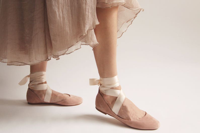 ballet flats with long satin straps worn on feet