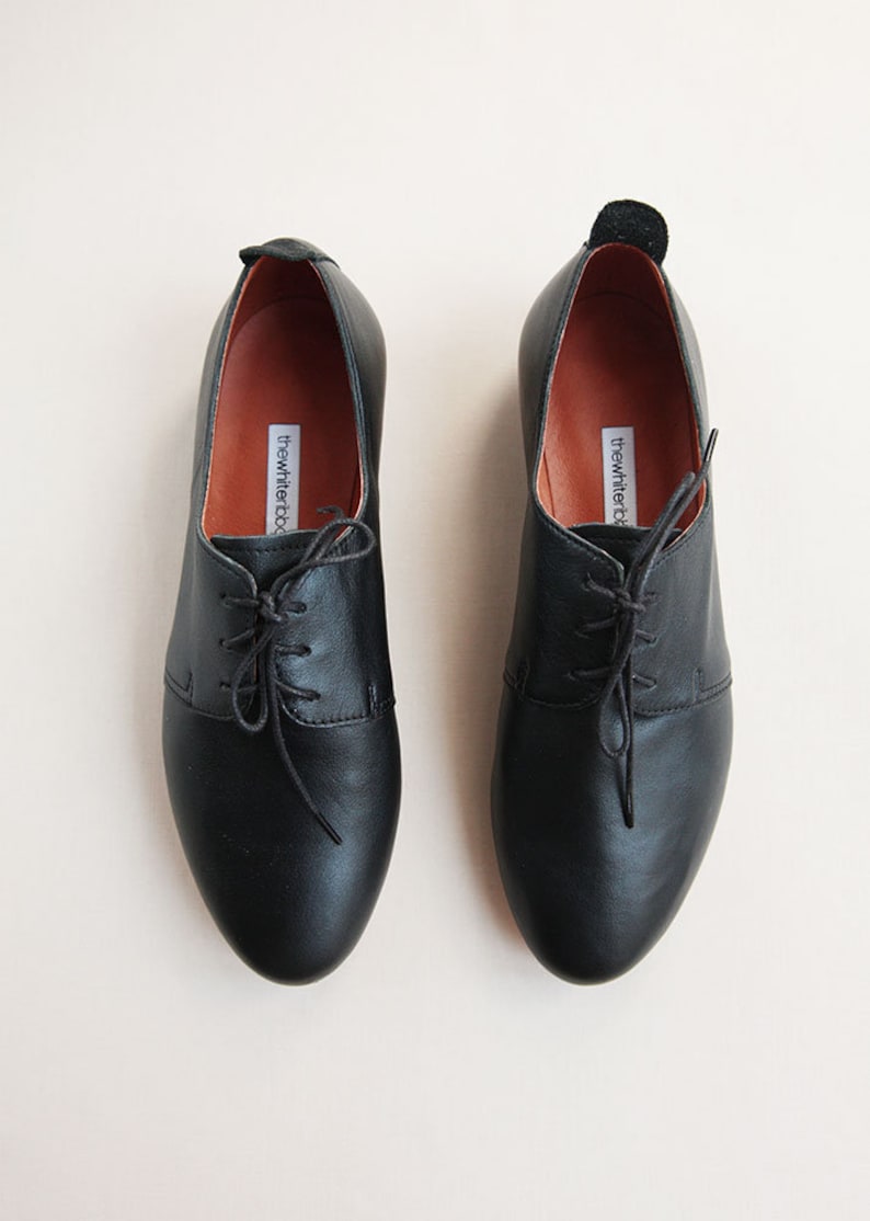 pair of black leather derby shoes shown from the top