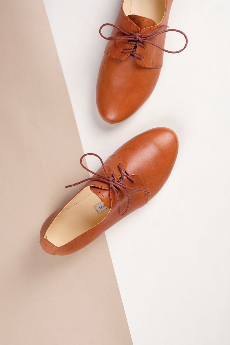 closeup top view of a pair of latte brown oxford shoes