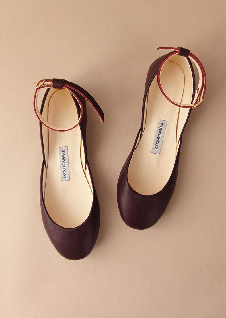 pair of bordeaux smooth leather ballerinas with leather ankle straps shown from top view