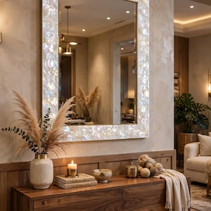 May include: A rectangular wall mirror featuring a wide frame inlaid with iridescent white mother-of-pearl tiles. The mirror reflects an interior space. The logo ALHAMDHANDICRAFTART DECORATIVE FURNITURE is visible in the bottom right corner.