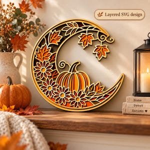 May include: A circular layered wooden wall art piece featuring a crescent moon shape, decorated with carved maple leaves, sunflowers, and a central pumpkin. The design includes the text Layered SVG design at the top right corner.