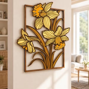 May include: A rectangular wall art piece featuring a layered wooden design of three yellow and orange daffodils. The flowers and stems are enclosed within a thin, dark brown wooden frame, creating a dimensional effect with distinct petals.