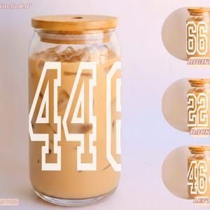 May include: A clear glass tumbler with a bamboo lid and a straw included. The glass features large white varsity-style numbers 446 on the front, with additional views showing numbers 662, 224, and 464 on the right, back, and left sides respectively.