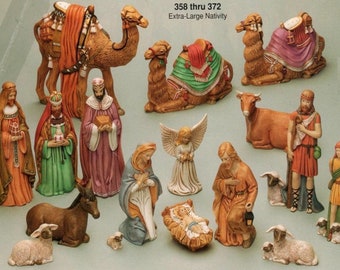 May include: An extra-large nativity set featuring figures of the Holy Family, the Three Wise Men, angels, and animals. The figures are painted in various colors, including brown, gold, and blue. The set includes camels, a donkey, and sheep.