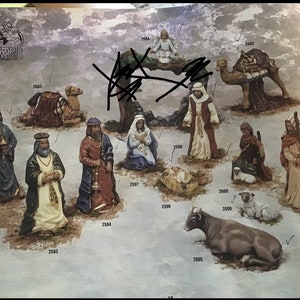 May include: A nativity scene set with figurines of the three wise men, Mary, Joseph, baby Jesus, a camel, a cow, a sheep, and an angel. The figurines are painted in various colors, including red, blue, green, and gold.