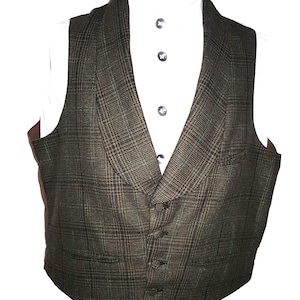 May include: A green and brown plaid vest with a notched lapel and four buttons. The vest is worn over a white collared shirt. The vest has a classic, tailored design.