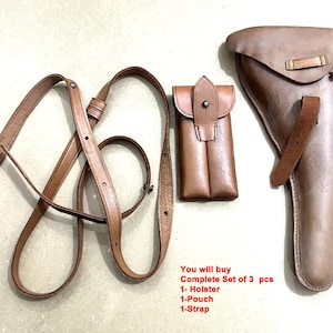 May include: A complete set of three leather accessories: a holster, a pouch, and a strap. The items are in a light brown color. The holster is designed to hold a pistol. The pouch is small and rectangular. The strap is long and adjustable.
