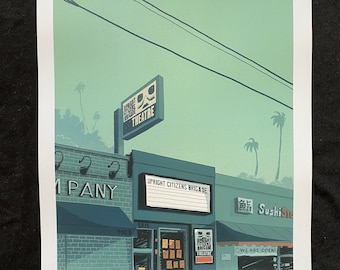 May include: A green and blue illustration of a building with a sign that reads "Upright Citizens Brigade Theatre". The building is located on a street with palm trees and power lines. The sign is above a storefront with a sign that reads "Upright Citizens Brigade".