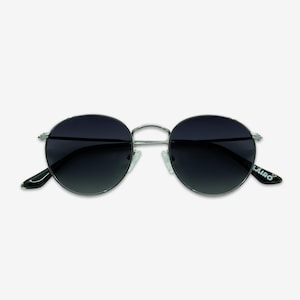 May include: Round sunglasses with a silver frame and dark lenses. The sunglasses have a classic design with a thin metal frame and a subtle gradient on the lenses. The brand name "LAIRO" is printed on the left arm.