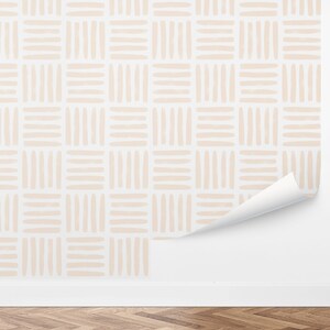 May include: A beige and white wallpaper with a geometric pattern of horizontal and vertical lines. The wallpaper is shown on a white wall with a wooden floor.