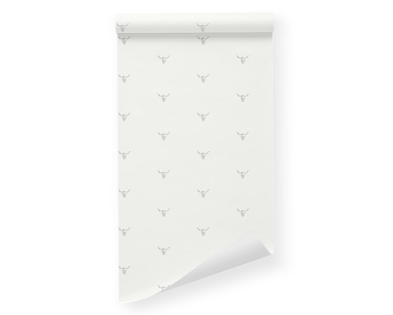 May include: A white wallpaper roll with a repeating pattern of gray bull skulls.